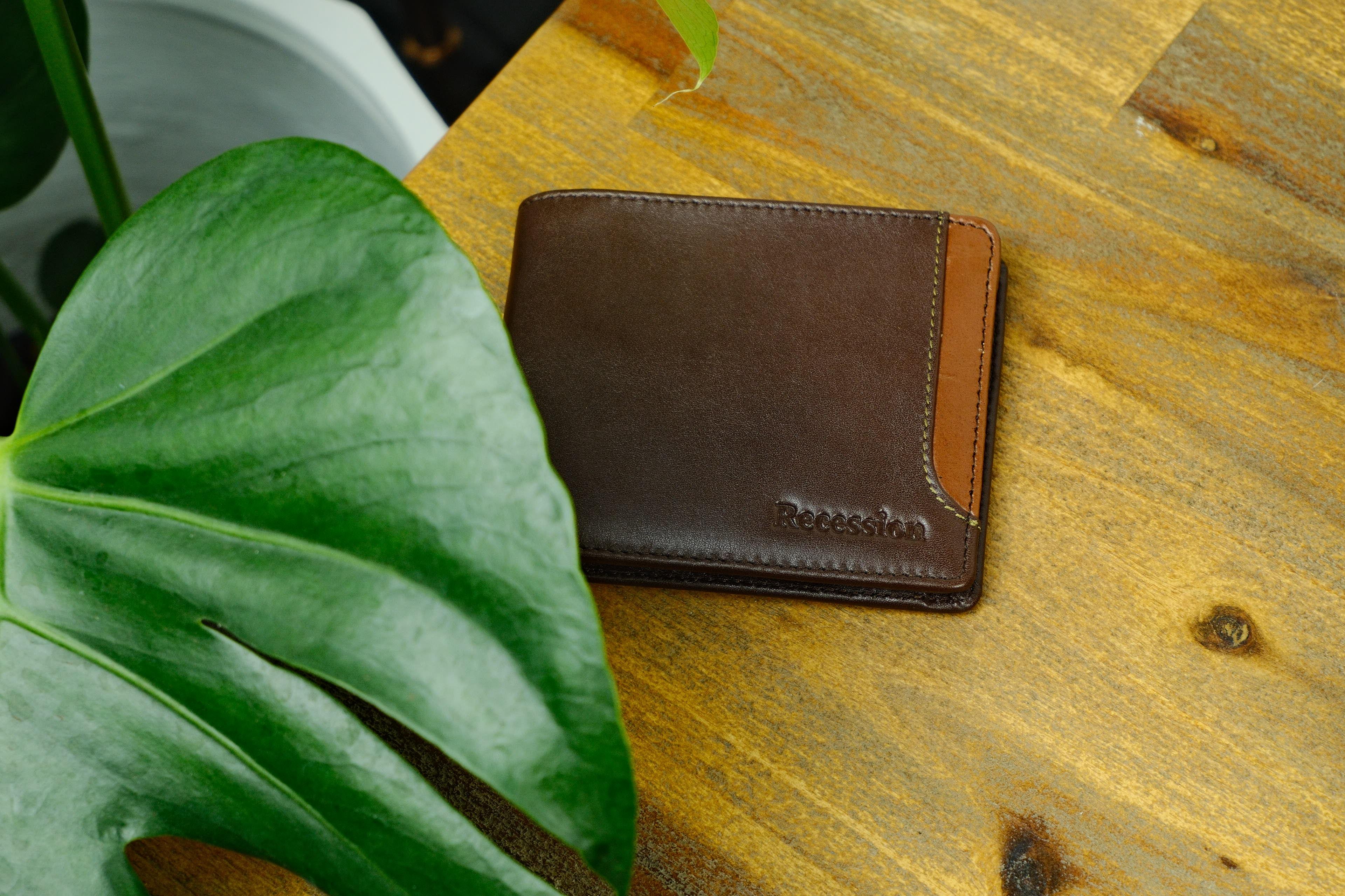 Full-grain leather wallets on a wooden table